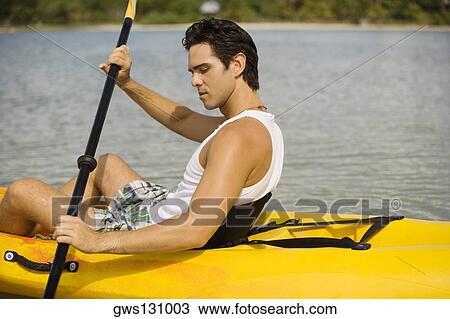 Side profile of a young man kayaking in a lake View Large Photo Image Stock Image - Side profile of a young man kayaking in a lake. Fotosearch