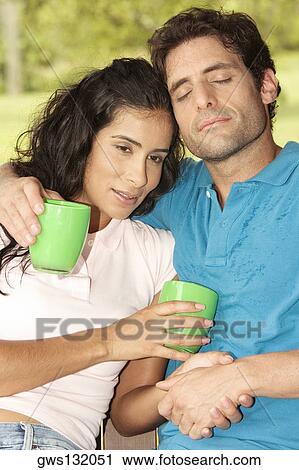 Close-up of a mid adult man and a young woman holding coffee cups View Large Photo Image Stock Image - Close-up of a mid adult man and a young woman holding coffee cups. Fotosearch