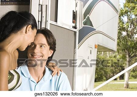Close-up of a mid adult man and a young woman looking at each other View Large Photo Image Stock Photograph - Close-up of a mid adult man and a young woman looking at each other. Fotosearch