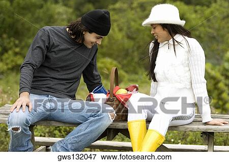 Close-up of a young couple sitting together View Large Photo Image Stock Photo - Close-up of a young couple sitting together. Fotosearch