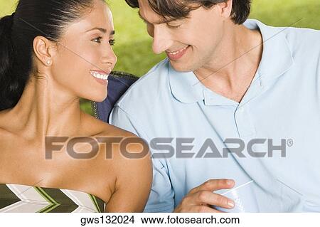 Close-up of a young woman and a mid adult man smiling View Large Photo Image Picture - Close-up of a young woman and a mid adult man smiling. Fotosearch