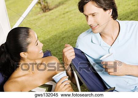 Close-up of a young woman and a mid adult man smiling View Large Photo Image Stock Photography - Close-up of a young woman and a mid adult man smiling. Fotosearch