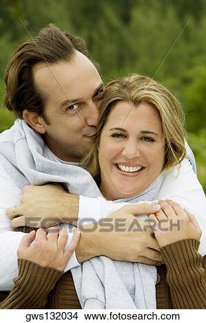 Portrait of a mature man kissing a mid adult woman View Large Photo Image Picture - Portrait of a mature man kissing a mid adult woman. Fotosearch