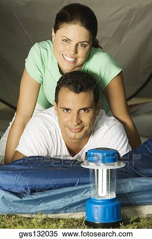 Portrait of a young couple lying in a tent View Large Photo Image Stock Photography - Portrait of a young couple lying in a tent. Fotosearch