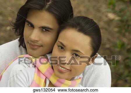 Portrait of a young couple smiling View Large Photo Image Picture - Portrait of a young couple smiling. Fotosearch