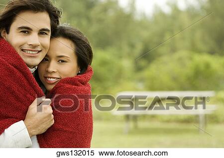 Stock Photography - Portrait of a young couple smiling. Fotosearch