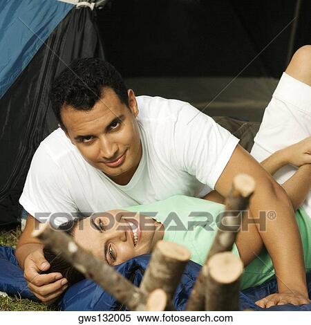 Stock Photography - Portrait of a young man lying in a tent. Fotosearch