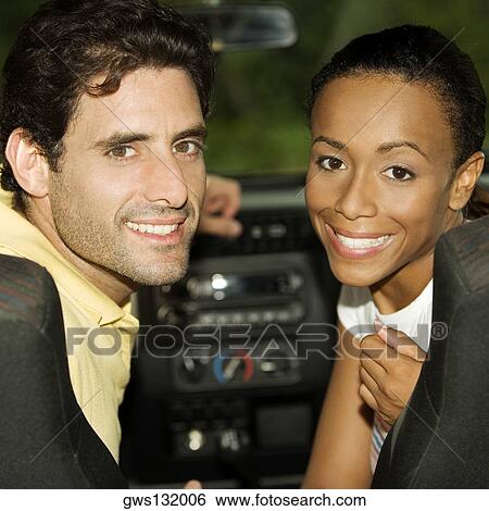 Portrait of a young woman and a mid adult man sitting in a car View Large Photo Image Stock Photograph - Portrait of a young woman and a mid adult man sitting in a car. Fotosearch
