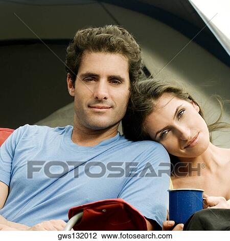 Portrait of a young woman leaning her head on a mid adult man's shoulder View Large Photo Image Stock Image - Portrait of a young woman leaning her head on a mid adult man's shoulder. Fotosearch
