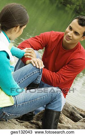Young man holding a young woman's hand View Large Photo Image Stock Image - Young man holding a young woman's hand. Fotosearch