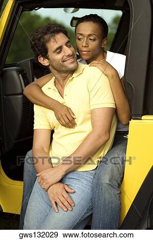Young woman embracing a mid adult man from behind View Large Photo Image Stock Photo - Young woman embracing a mid adult man from behind. Fotosearch