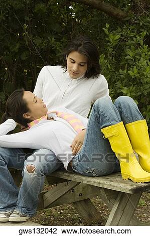 Young woman lying on a young man's lap View Large Photo Image Stock Image - Young woman lying on a young man's lap. Fotosearch