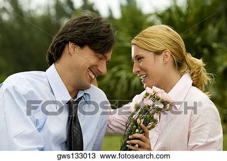 Close-up of a businessman and a businesswoman smiling in the park View Large Photo Image Stock Image - Close-up of a businessman and a businesswoman smiling in the park. Fotosearch