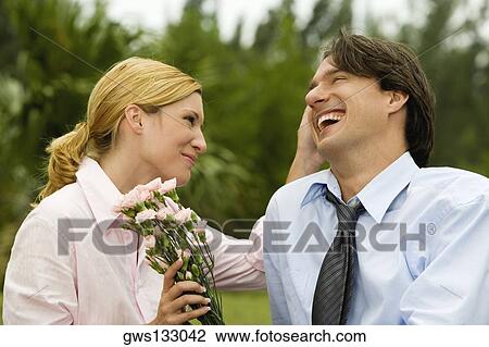 Close-up of a businessman and a businesswoman smiling in the park View Large Photo Image Stock Image - Close-up of a businessman and a businesswoman smiling in the park. Fotosearch