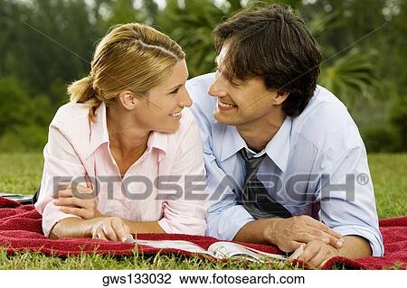 Stock Image - Close-up of a businesswoman and a businessman looking at each other. Fotosearch
