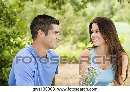 Close-up of a mid adult man and a young woman smiling View Large Photo Image Stock Image - Close-up of a mid adult man and a young woman smiling. Fotosearch