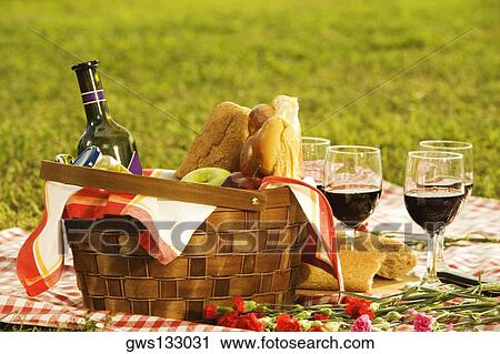 Close-up of a wine bottle with bread and fruits in a picnic basket View Large Photo Image Stock Image - Close-up of a wine bottle with bread and fruits in a picnic basket. Fotosearch