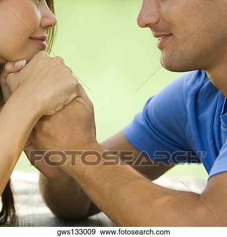 Close-up of a young woman holding a mid adult man's hand View Large Photo Image Stock Photo - Close-up of a young woman holding a mid adult man's hand. Fotosearch