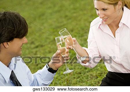 High angle view of a businessman and a businesswoman toasting with champagne flutes View Large Photo Image Stock Photo - High angle view of a businessman and a businesswoman toasting with champagne flutes. Fotosearch
