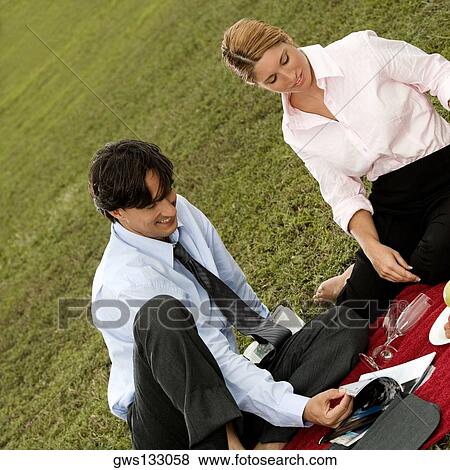 High angle view of a businessman and a businesswoman sitting together in the park View Large Photo Image Stock Photo - High angle view of a businessman and a businesswoman sitting together in the park. Fotosearch