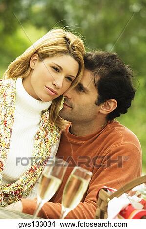 Mid adult man talking to a young woman View Large Photo Image Picture - Mid adult man talking to a young woman. Fotosearch