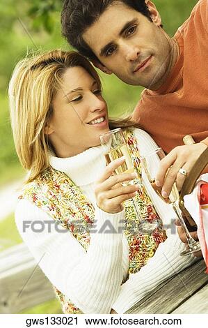 Young woman and a mid adult man drinking wine View Large Photo Image Stock Image - Young woman and a mid adult man drinking wine. Fotosearch