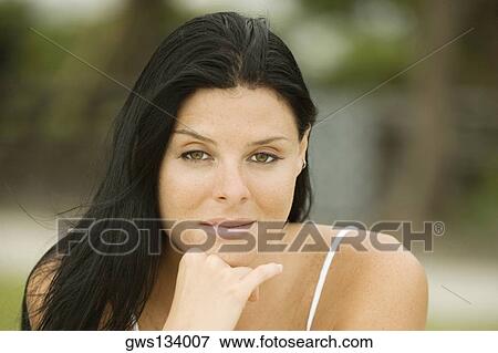 Close-up of a young woman with her hand under her chin View Large Photo Image Stock Photo - Close-up of a young woman with her hand under her chin. Fotosearch
