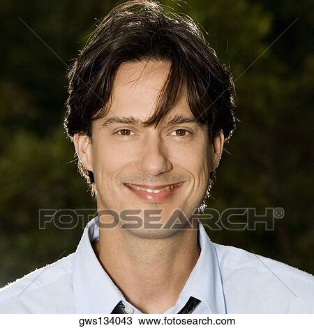 Portrait of a businessman smiling View Large Photo Image Stock Image - Portrait of a businessman smiling. Fotosearch