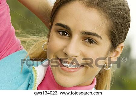 Portrait of a girl with her hand behind her head View Large Photo Image Stock Image - Portrait of a girl with her hand behind her head. Fotosearch