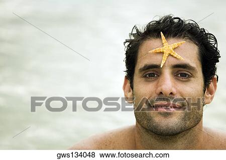 Portrait of a mid adult man with a starfish on his forehead View Large Photo Image Stock Photo - Portrait of a mid adult man with a starfish on his forehead. Fotosearch
