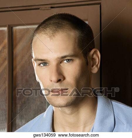 Portrait of a young man looking serious View Large Photo Image Stock Photo - Portrait of a young man looking serious. Fotosearch