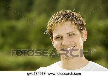 Portrait of a young man smiling View Large Photo Image Stock Photo - Portrait of a young man smiling. Fotosearch