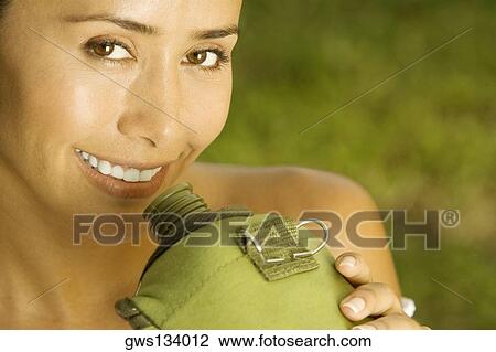 Portrait of a young woman holding a water bottle View Large Photo Image Stock Image - Portrait of a young woman holding a water bottle. Fotosearch