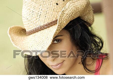 Portrait of a young woman wearing a hat View Large Photo Image Stock Photo - Portrait of a young woman wearing a hat. Fotosearch