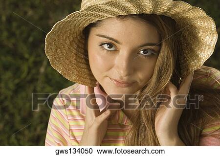 Portrait of a young woman wearing a straw hat View Large Photo Image Stock Image - Portrait of a young woman wearing a straw hat. Fotosearch