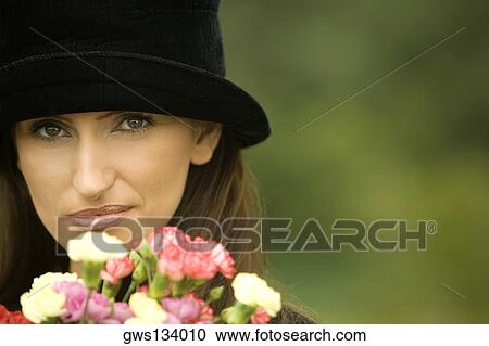 Portrait of a young woman with flowers in front of her View Large Photo Image Stock Image - Portrait of a young woman with flowers in front of her. Fotosearch