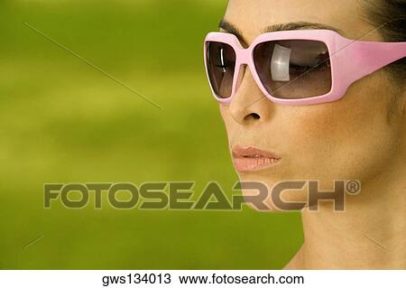 Side profile of a mid adult woman wearing sunglasses View Large Photo Image Stock Image - Side profile of a mid adult woman wearing sunglasses. Fotosearch