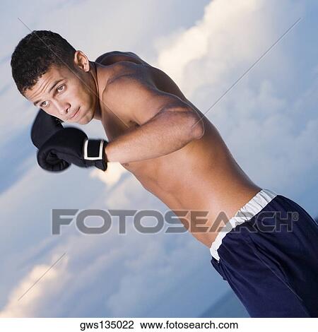 Close-up of a young man in a fighting stance View Large Photo Image Stock Image - Close-up of a young man in a fighting stance. Fotosearch
