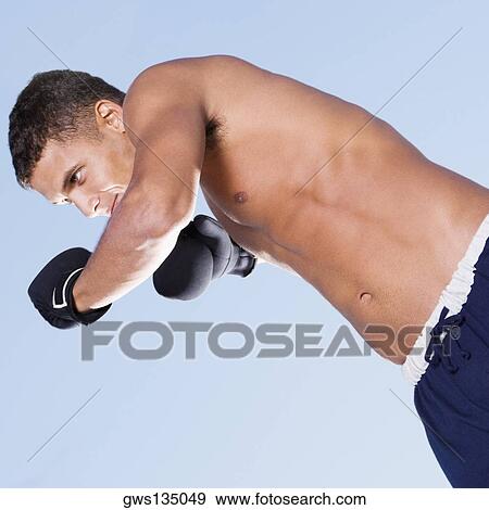 Close-up of a young man in a fighting stance View Large Photo Image Stock Photo - Close-up of a young man in a fighting stance. Fotosearch