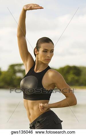 Close-up of a young woman practicing martial arts on the beach View Large Photo Image Stock Photograph - Close-up of a young woman practicing martial arts on the beach. Fotosearch