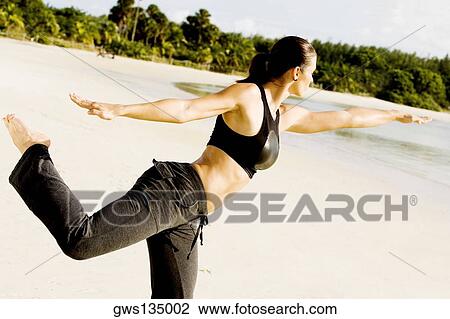 Side profile of a young woman practicing martial arts on the beach View Large Photo Image Stock Image - Side profile of a young woman practicing martial arts on the beach. Fotosearch
