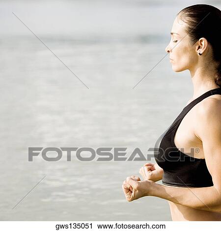 Side profile of a young woman practicing martial arts View Large Photo Image Stock Image - Side profile of a young woman practicing martial arts. Fotosearch