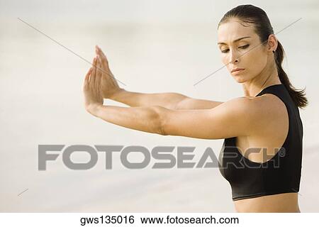 Side profile of a young woman practicing martial arts on the beach View Large Photo Image Stock Photograph - Side profile of a young woman practicing martial arts on the beach. Fotosearch