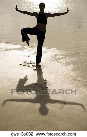 Silhouette of a young woman practicing martial arts on the beach View Large Photo Image Stock Image - Silhouette of a young woman practicing martial arts on the beach. Fotosearch
