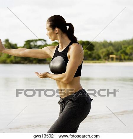 Young woman practicing martial arts on the beach View Large Photo Image Stock Image - Young woman practicing martial arts on the beach. Fotosearch