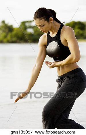 Young woman practicing martial arts on the beach View Large Photo Image Stock Photo - Young woman practicing martial arts on the beach. Fotosearch