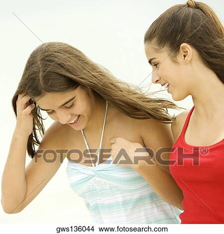 Picture - Close-up of a girl and a teenage girl looking cheerful. Fotosearch