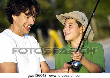 Father and his son fishing on the beach View Large Photo Image Stock Photo - Father and his son fishing on the beach. Fotosearch