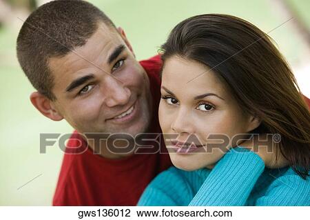 Stock Image - Portrait of a young couple smiling. Fotosearch