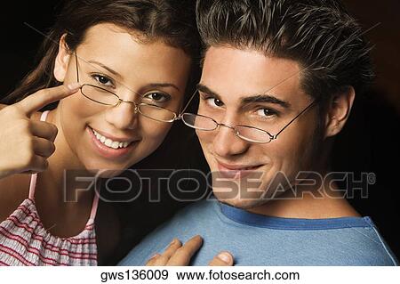 Portrait of a young man and a teenage girl smiling View Large Photo Image Stock Photo - Portrait of a young man and a teenage girl smiling. Fotosearch